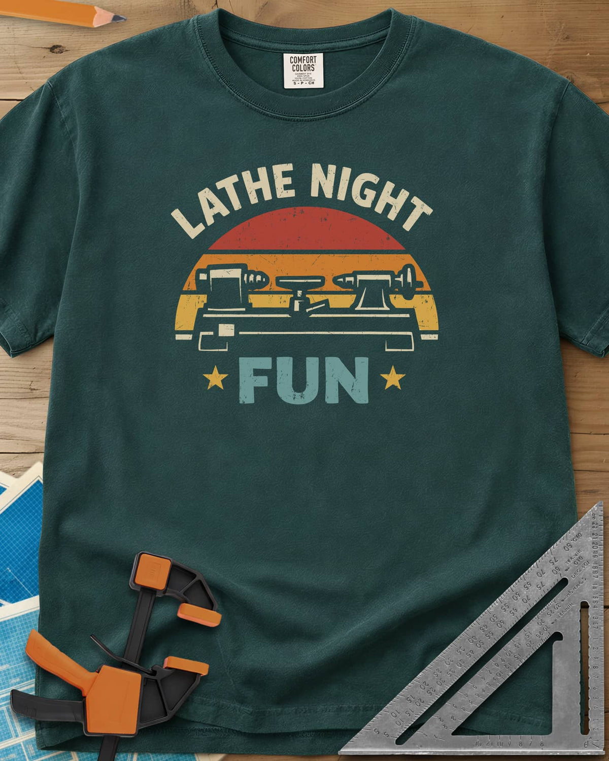 Lathe Night Fun heavyweight tee in Blue Spruce, a retro striped sunset behind a wood lathe with stars