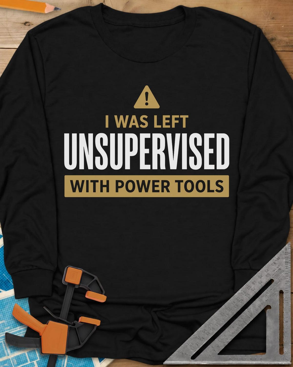 Left Unsupervised With Power Tools long sleeve shirt in Black, a warning triangle above bold lettering in a gold bar