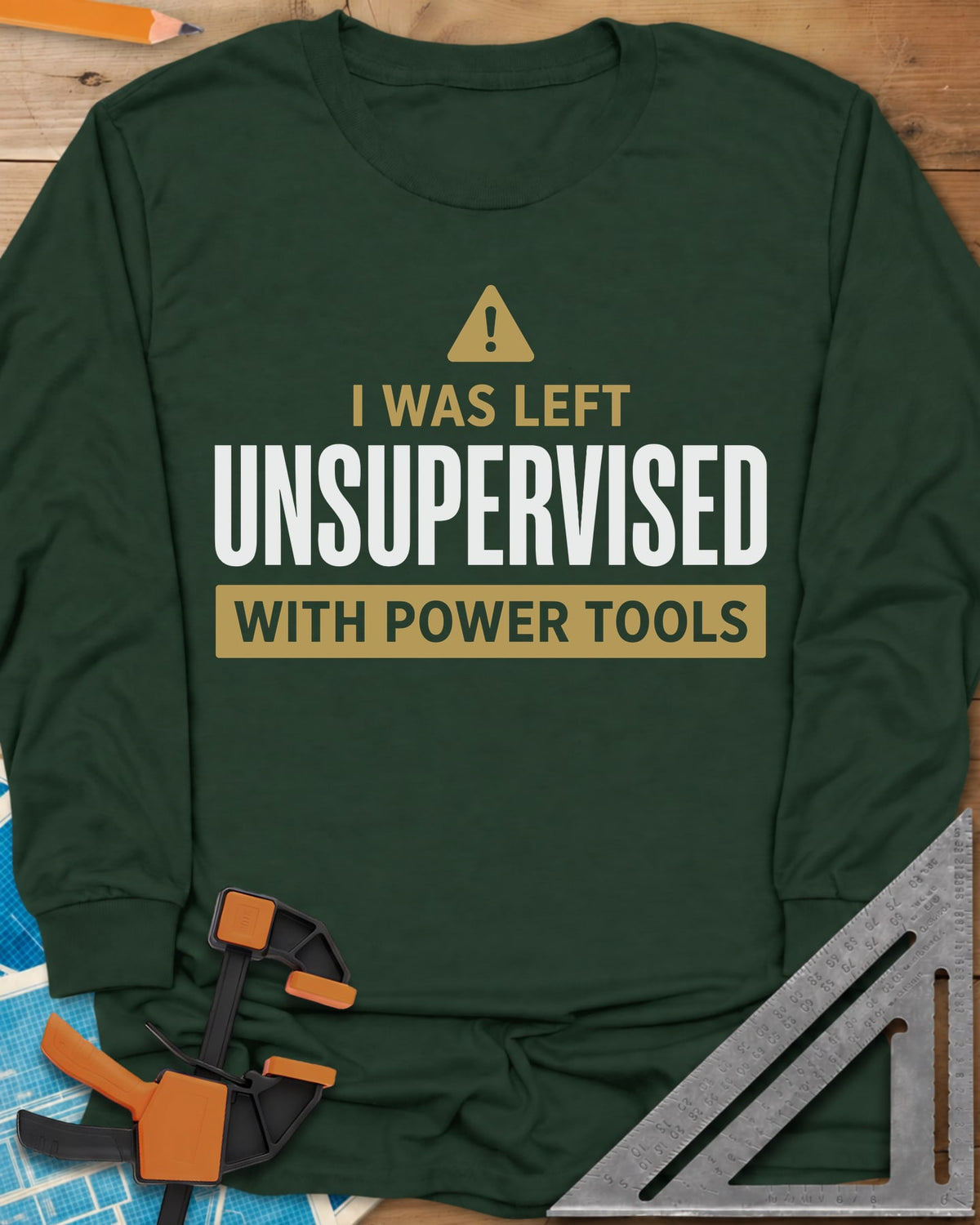 Left Unsupervised With Power Tools long sleeve shirt in Forest Green, a warning triangle above bold lettering in a gold bar