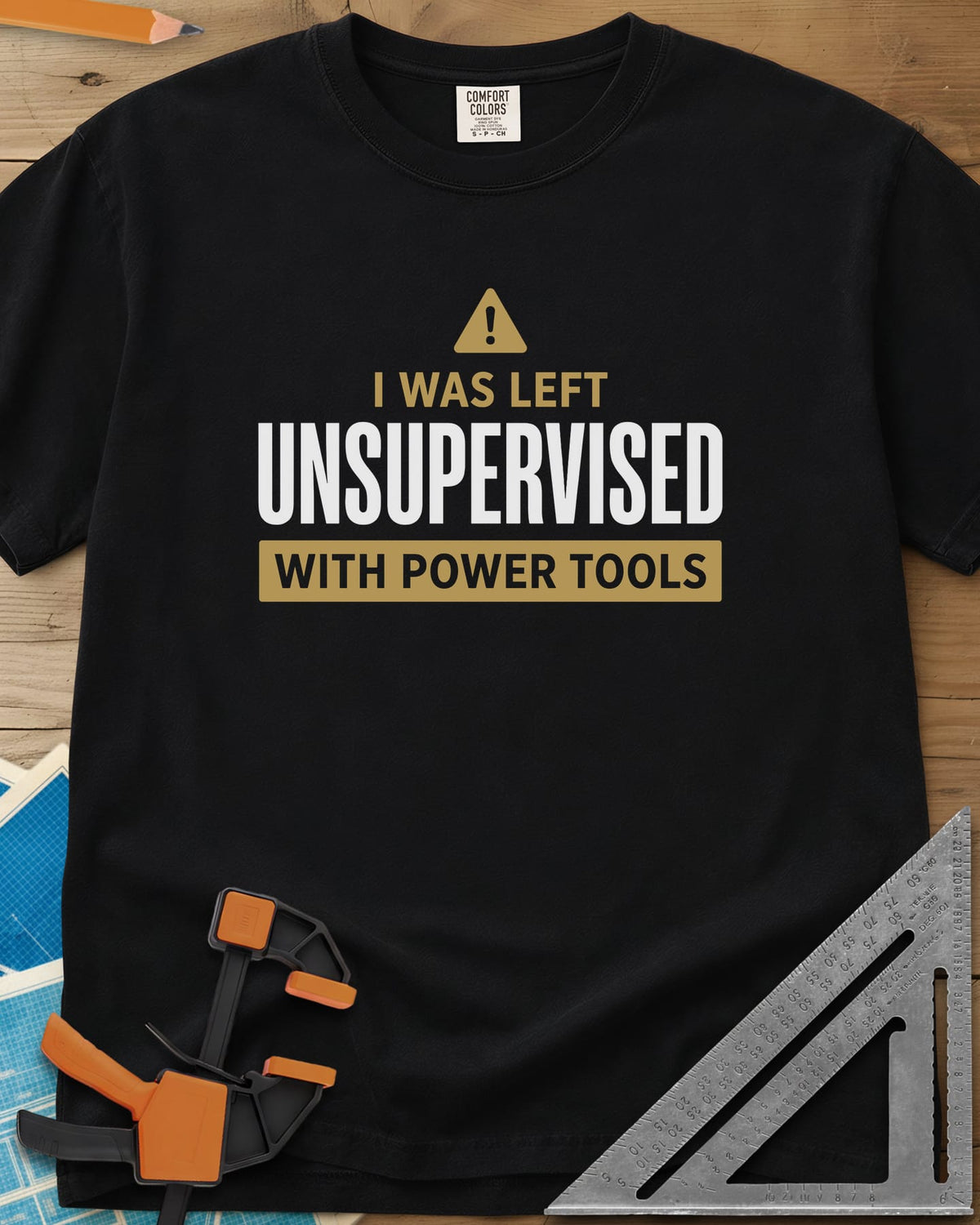 Left Unsupervised With Power Tools heavyweight tee in Black, a warning triangle above bold lettering in a gold bar