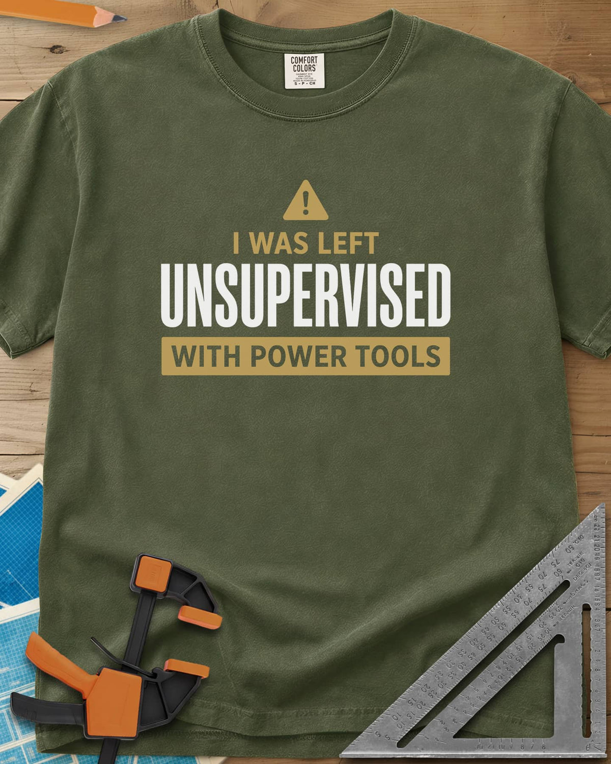 Left Unsupervised With Power Tools heavyweight tee in Hemp, a warning triangle above bold lettering in a gold bar
