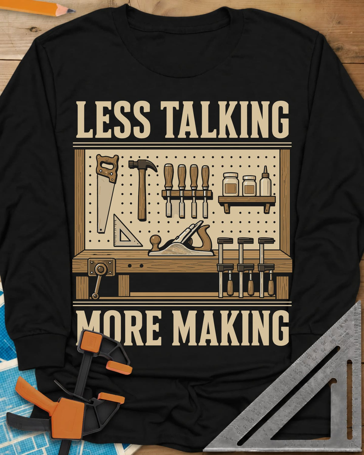 Less Talking More Making long sleeve shirt in Black, a pegboard of hand tools over a workbench with a plane and clamps
