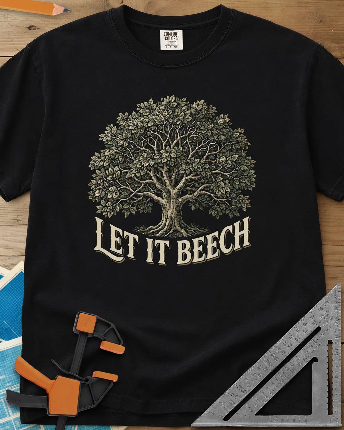 Let It Beech heavyweight tee in Black, a detailed beech tree in full leaf above curved cream lettering