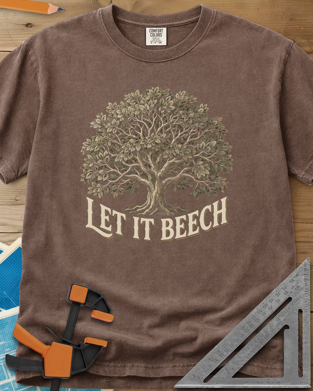 Let It Beech heavyweight tee in Espresso, a detailed beech tree in full leaf above curved cream lettering