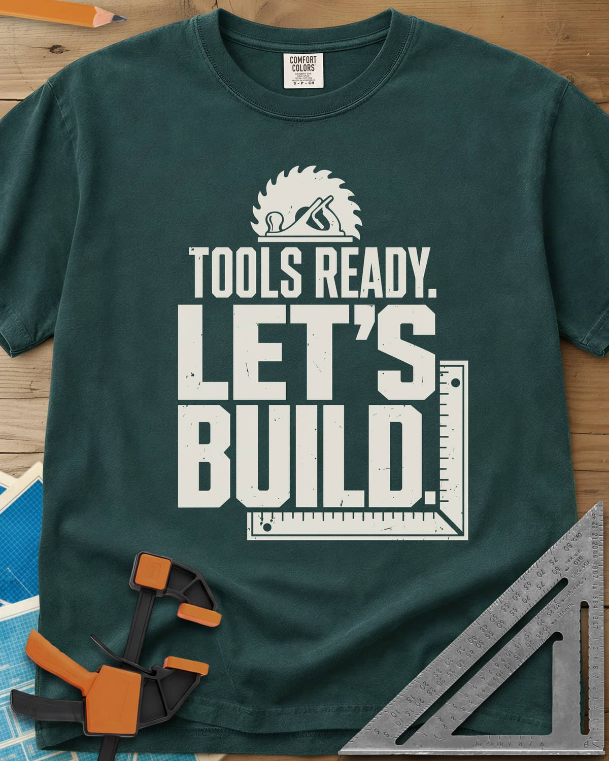Let'S Build heavyweight tee in Blue Spruce, a saw blade and hand plane over a framing square