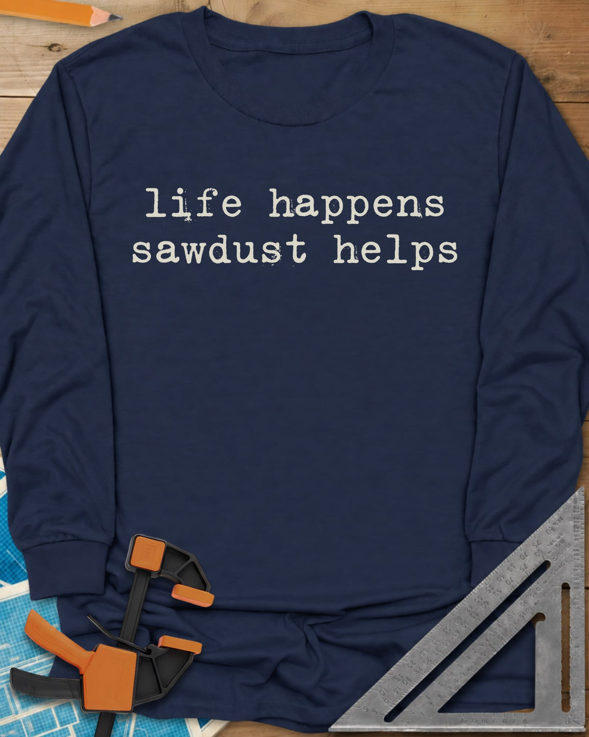 Life Happens Sawdust Helps long sleeve shirt in Navy, two lines of lowercase typewriter lettering, no graphic