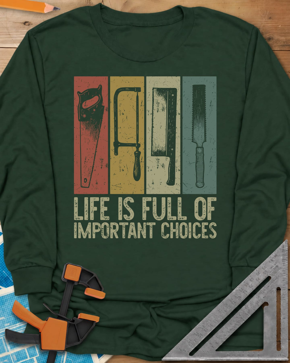 Life Is Full Of Important Choices long sleeve shirt in Forest Green, four hand saws in rust, mustard, cream and teal panels