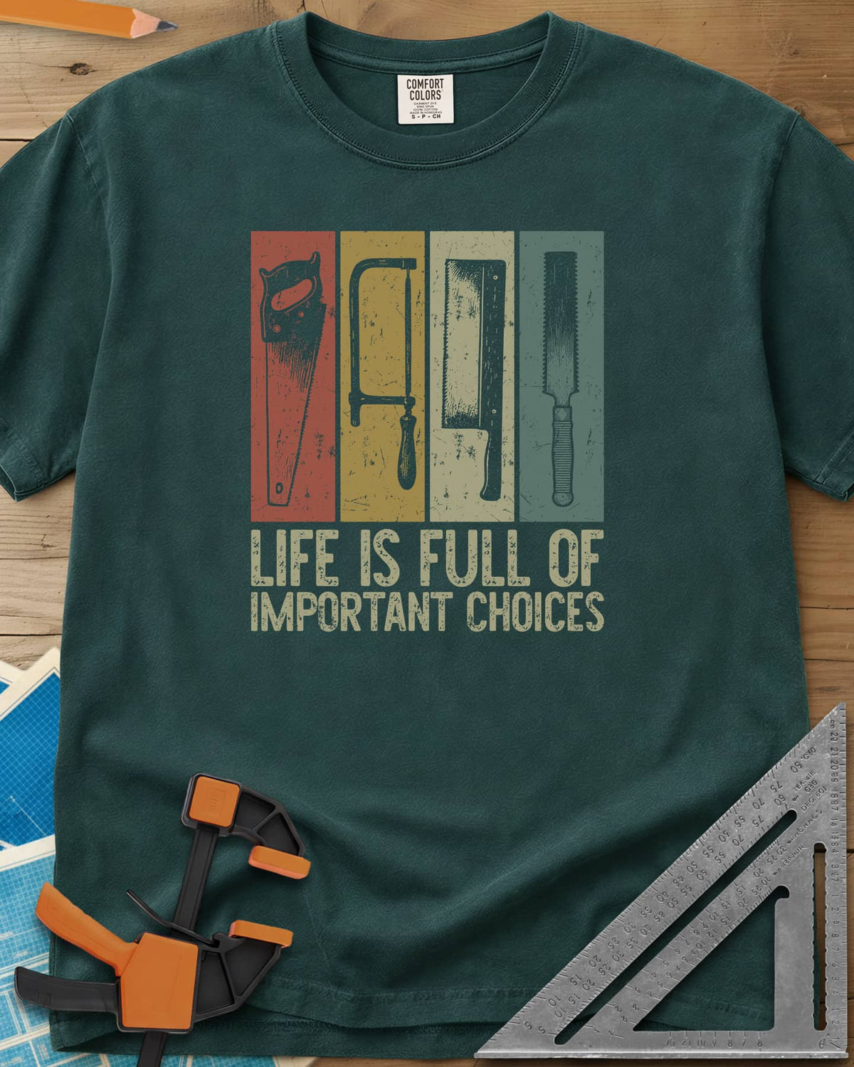 Life Is Full Of Important Choices heavyweight tee in Blue Spruce, four hand saws in rust, mustard, cream and teal panels