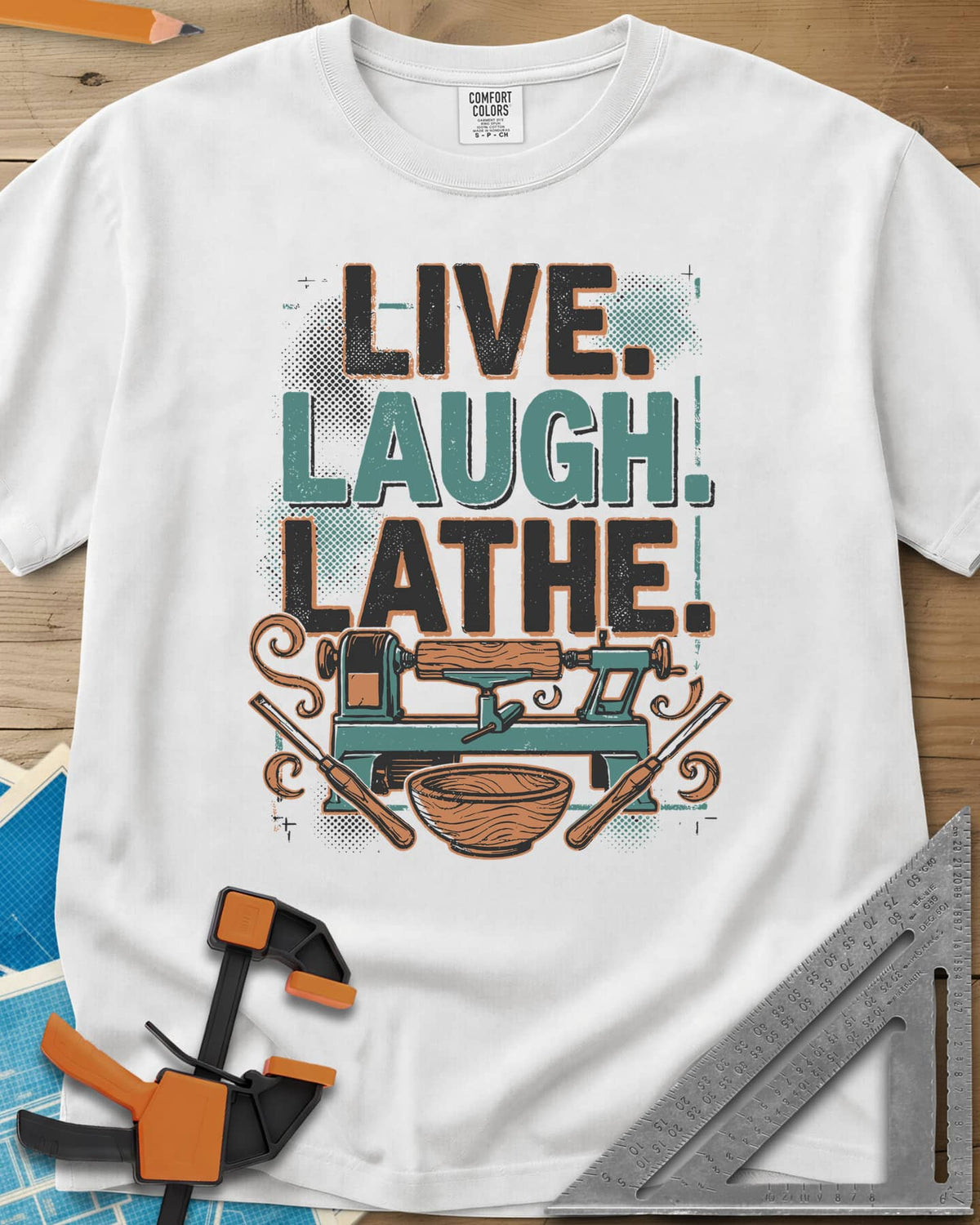 Live. Laugh. Lathe. heavyweight tee in White, a teal wood lathe with a bowl, two gouges and orange wood curls