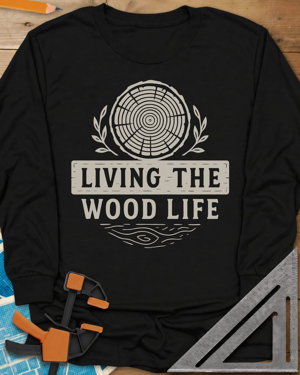Living The Wood Life long sleeve shirt in Black, a log slice with laurel sprigs and a plank banner