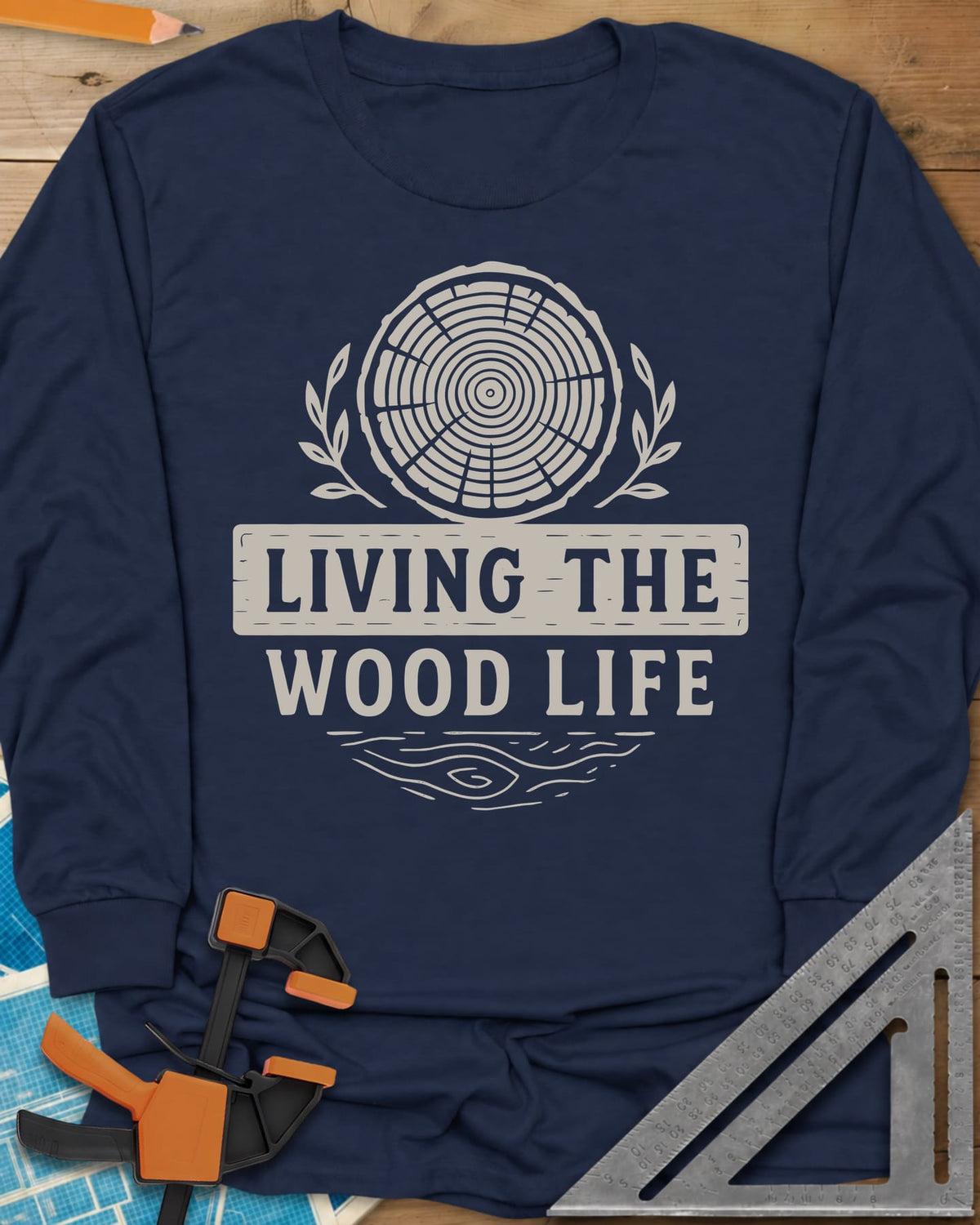 Living The Wood Life long sleeve shirt in Navy, a log slice with laurel sprigs and a plank banner