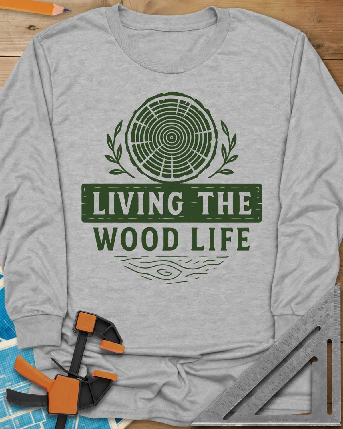 Living The Wood Life long sleeve shirt in Sport Grey, a log slice with laurel sprigs and a plank banner