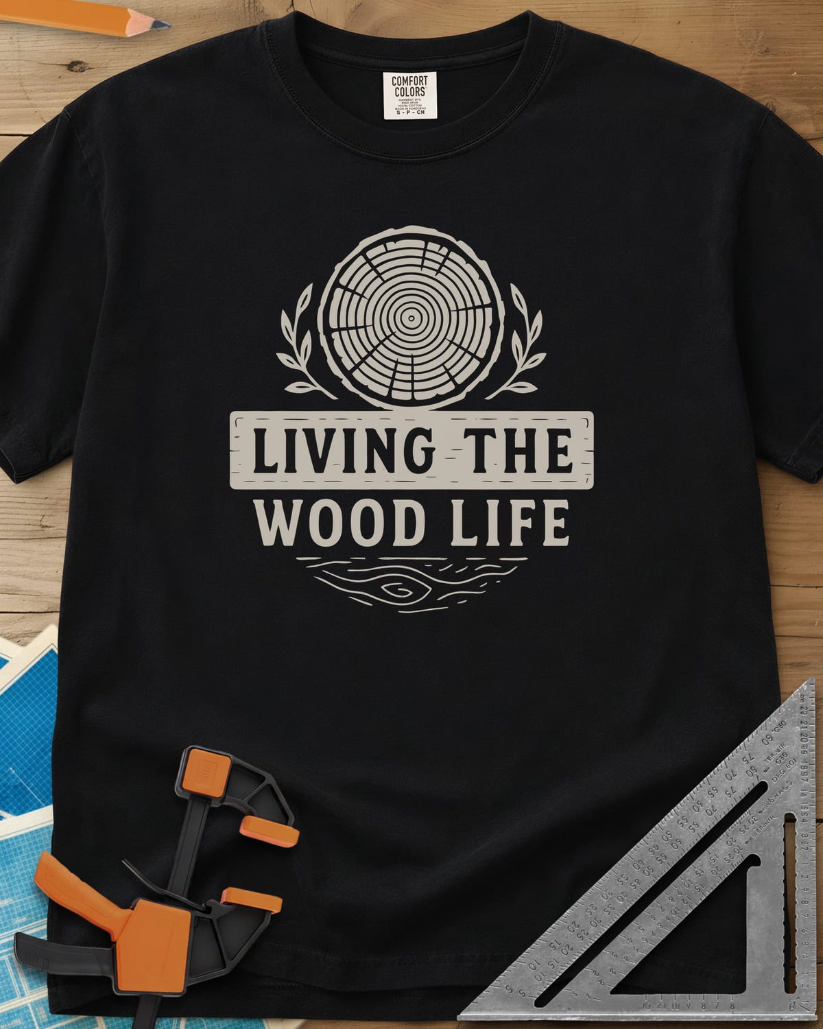 Living The Wood Life heavyweight tee in Black, a log slice with laurel sprigs and a plank banner