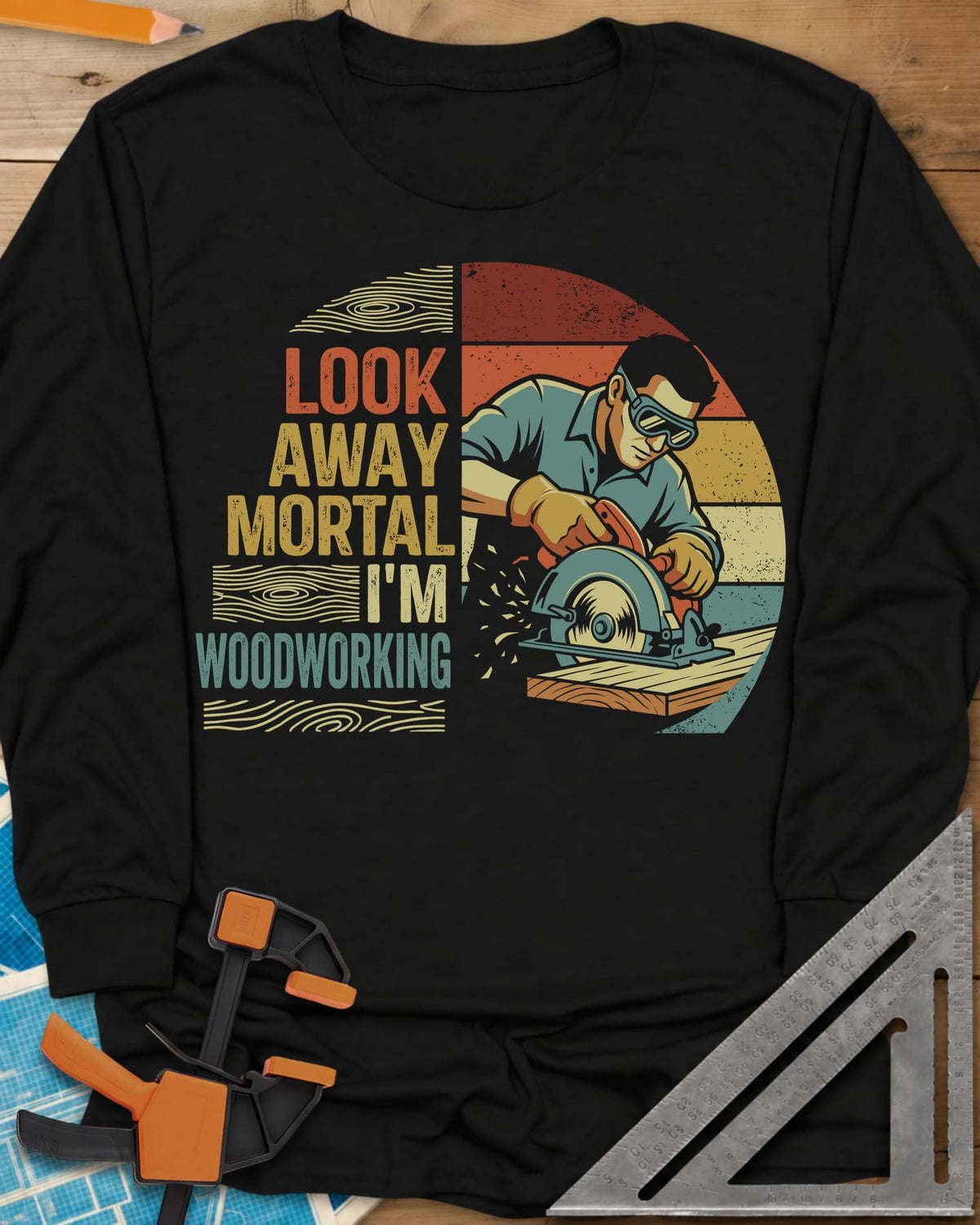 Look Away long sleeve shirt in Black, a goggled man cutting a board with a circular saw, retro stripes