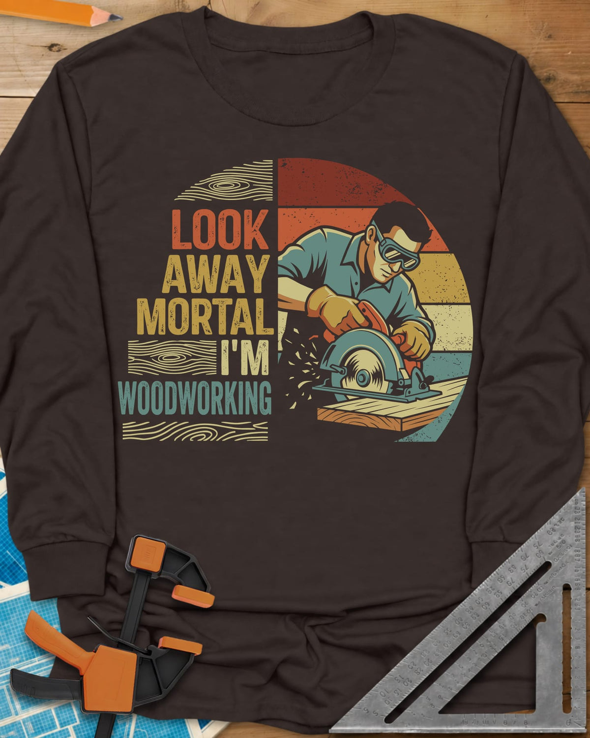 Look Away long sleeve shirt in Dark Chocolate, a goggled man cutting a board with a circular saw, retro stripes