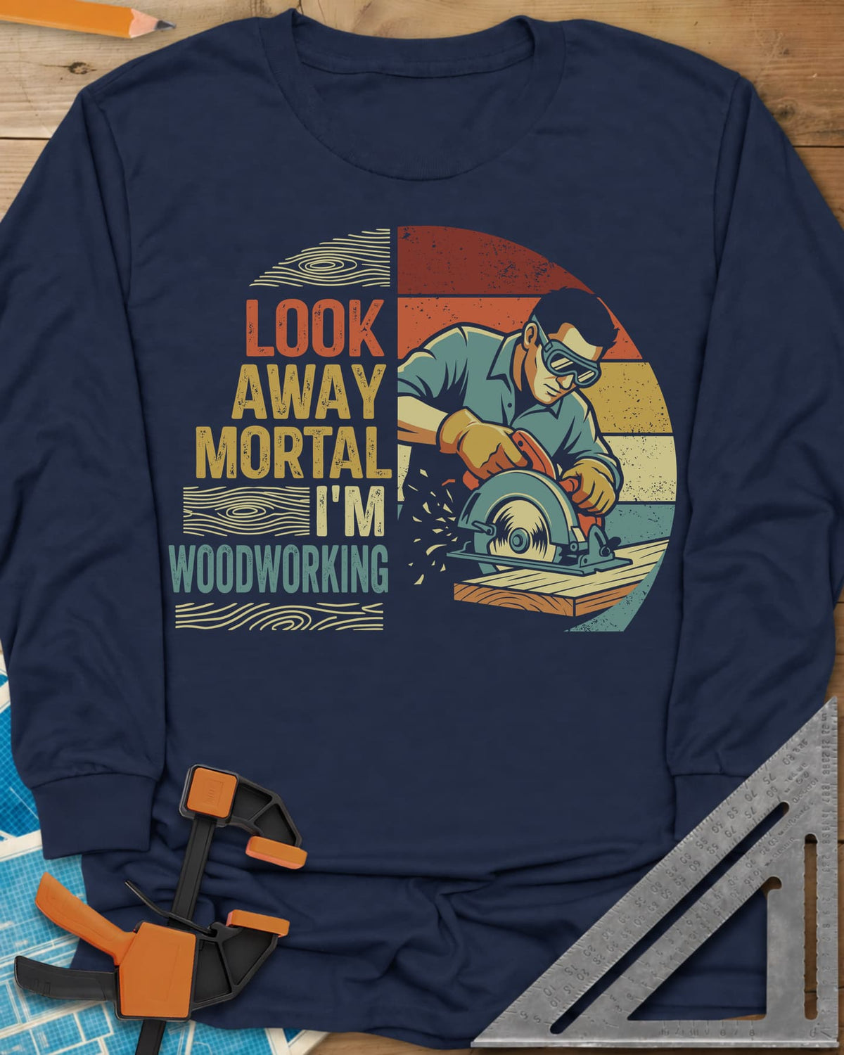 Look Away long sleeve shirt in Navy, a goggled man cutting a board with a circular saw, retro stripes