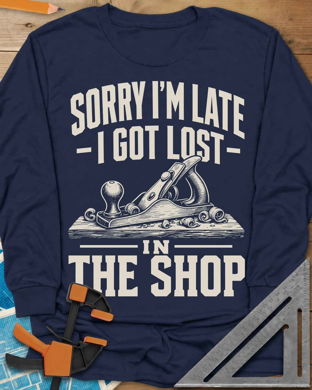 Lost In The Shop long sleeve shirt in Navy, a bench hand plane on a board among curled shavings