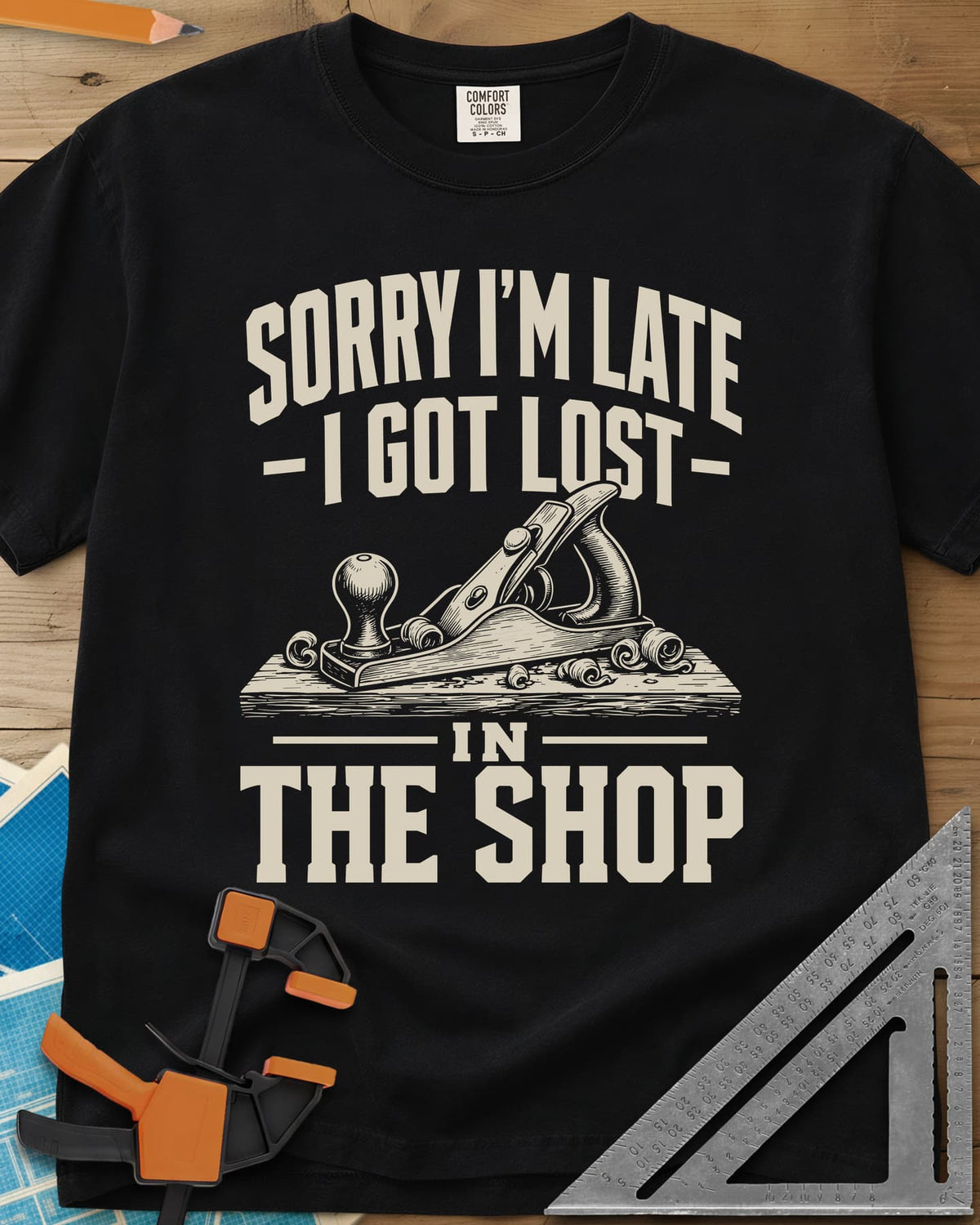 Lost In The Shop heavyweight tee in Black, a bench hand plane on a board among curled shavings