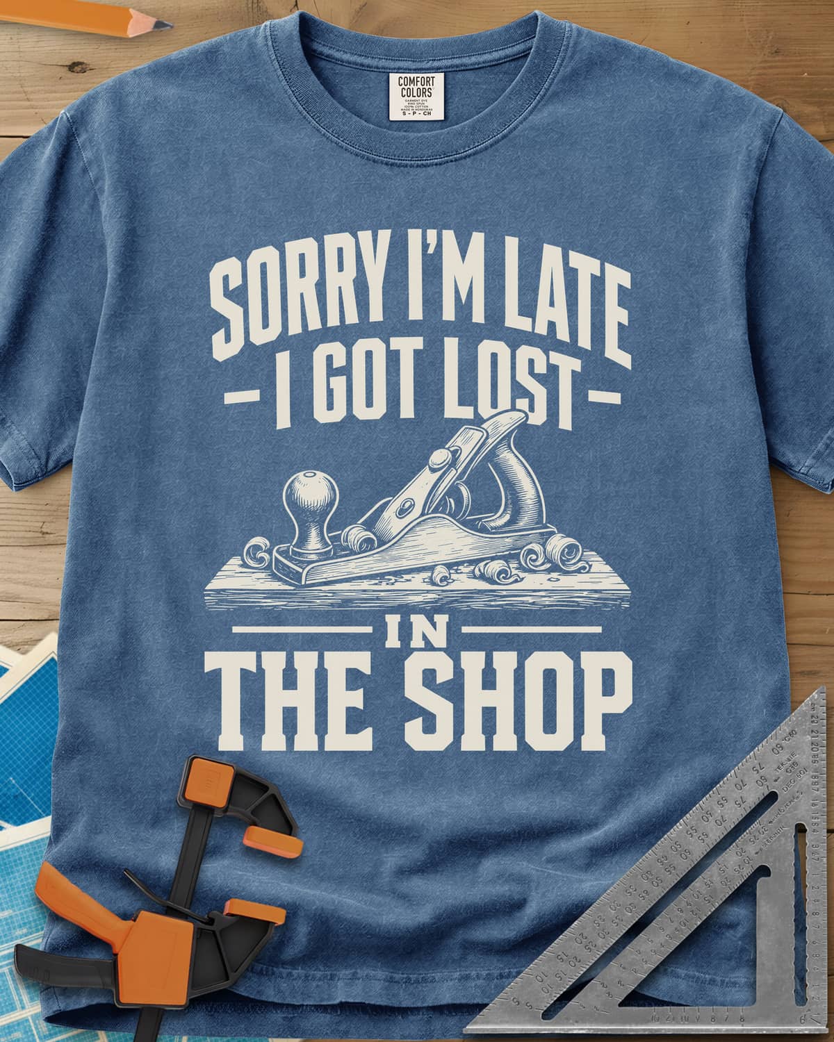 Lost In The Shop heavyweight tee in Blue Jean, a bench hand plane on a board among curled shavings