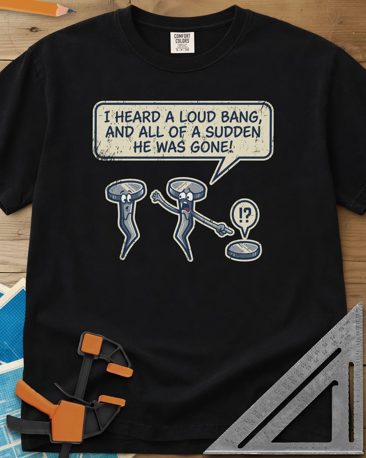 Loud Bang heavyweight tee in Black, two cartoon nails, one pointing at a lone nail head on the ground