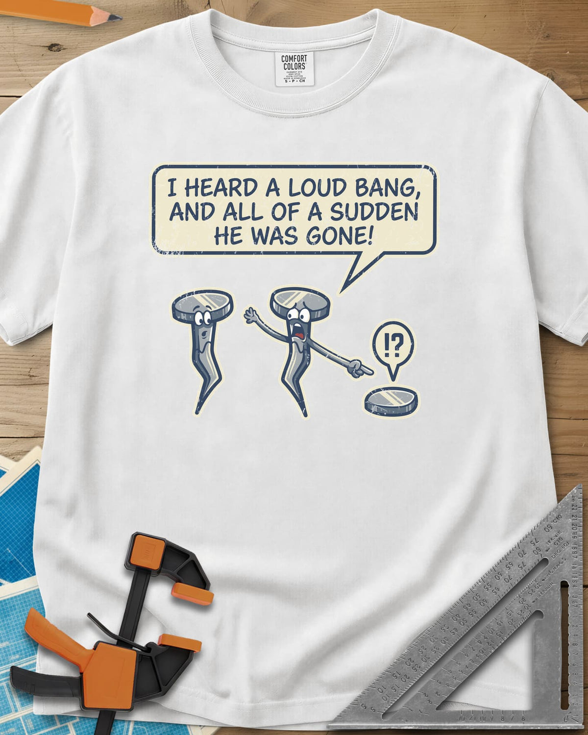 Loud Bang heavyweight tee in White, two cartoon nails, one pointing at a lone nail head on the ground
