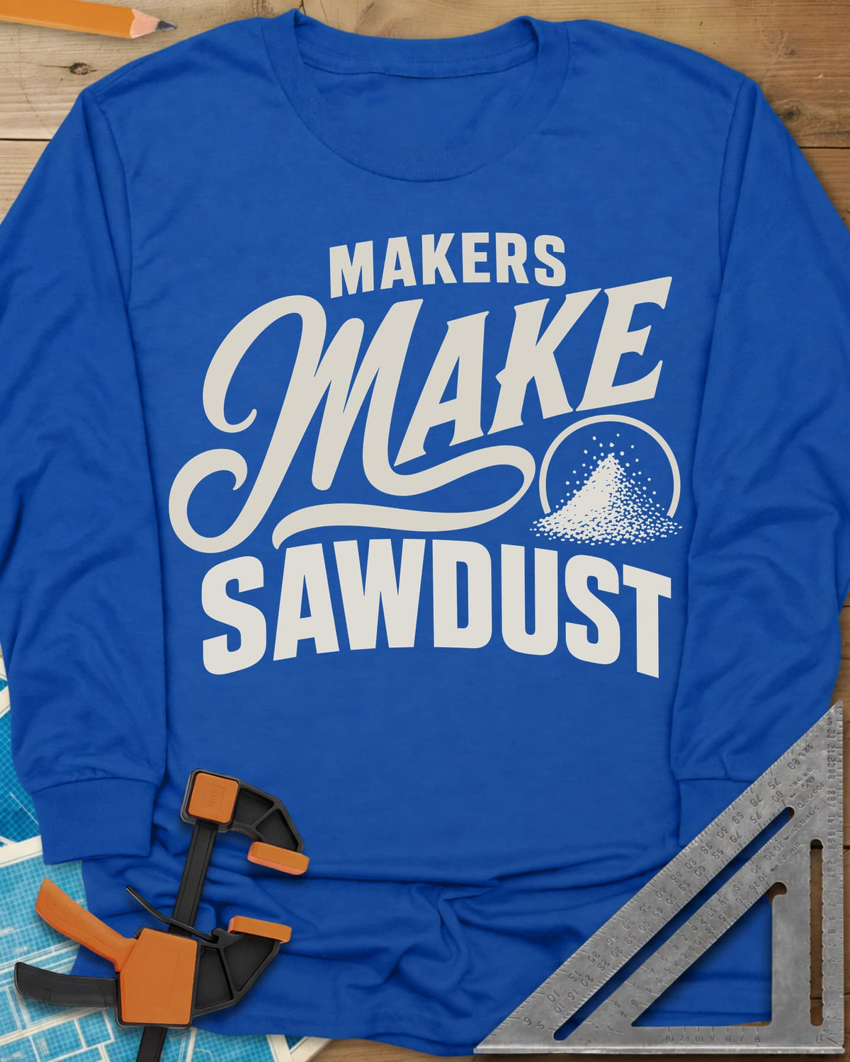 Make Sawdust long sleeve shirt in Royal, bold lettering with a script MAKE and a small pile of sawdust