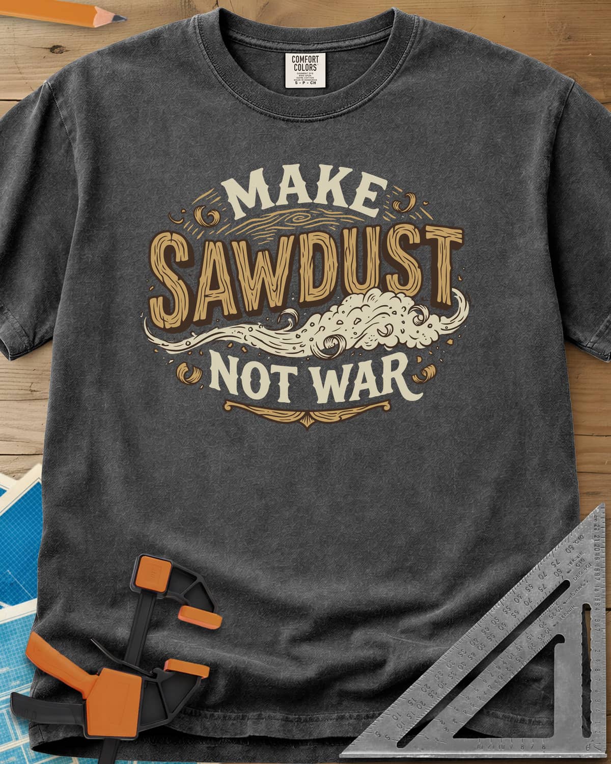 Make Sawdust Not War heavyweight tee in Pepper, vintage badge lettering with a swirl of blowing sawdust