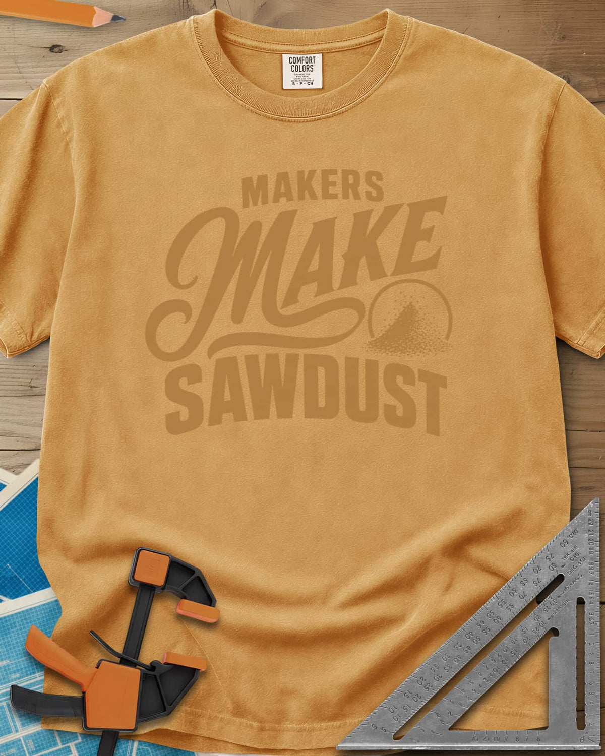 Make Sawdust heavyweight tee in Mustard, bold lettering with a script MAKE and a small pile of sawdust