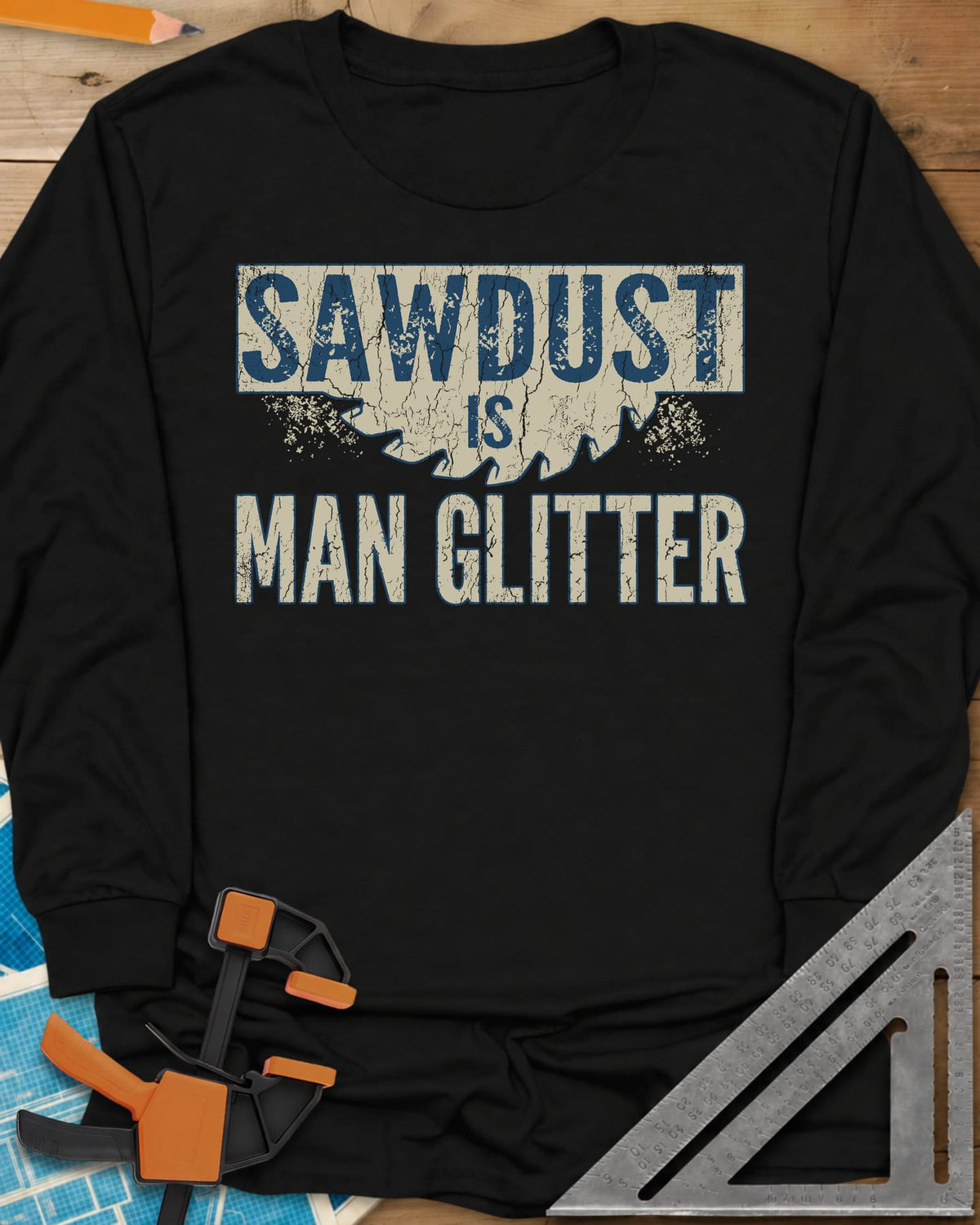 Man Glitter long sleeve shirt in Black, distressed lettering over a circular saw blade and sawdust specks