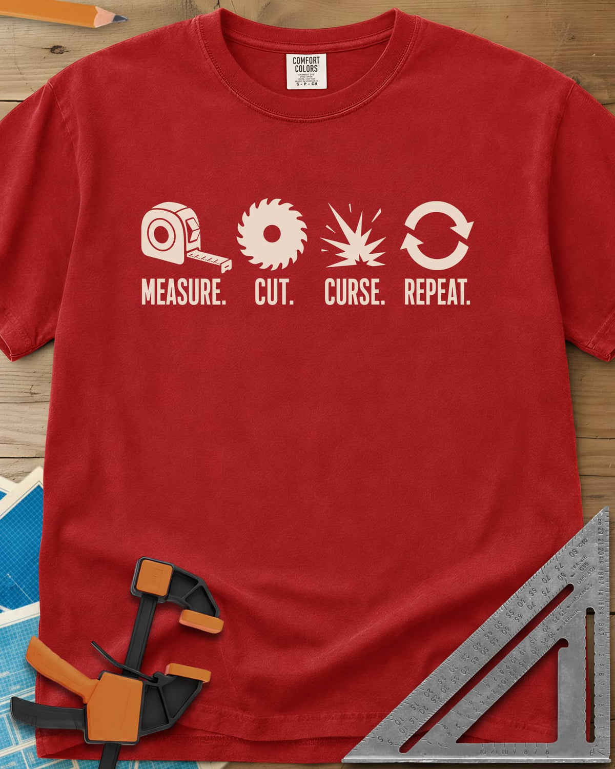 Measure Cut Repeat heavyweight tee in Red, four icons: tape measure, saw blade, spark burst, repeat arrows