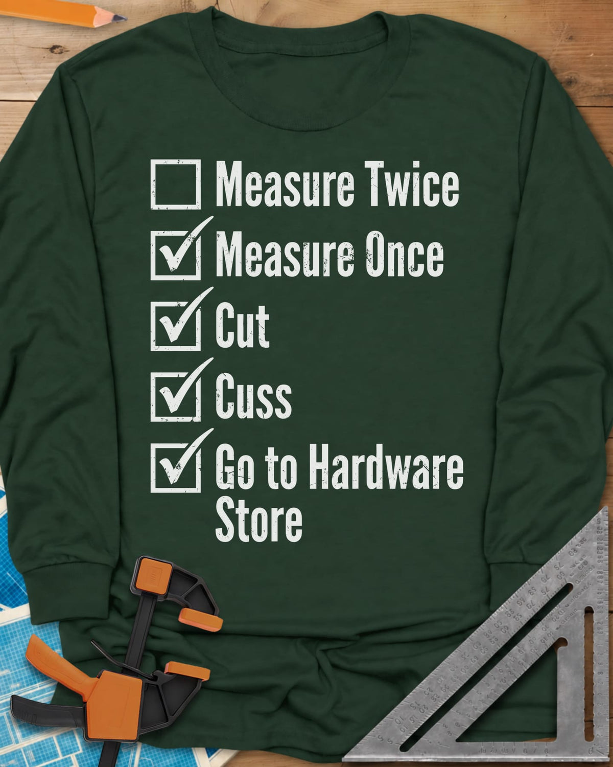 Measure Twice Checkbox long sleeve shirt in Forest Green, a five-line checklist with only the measure twice box left empty