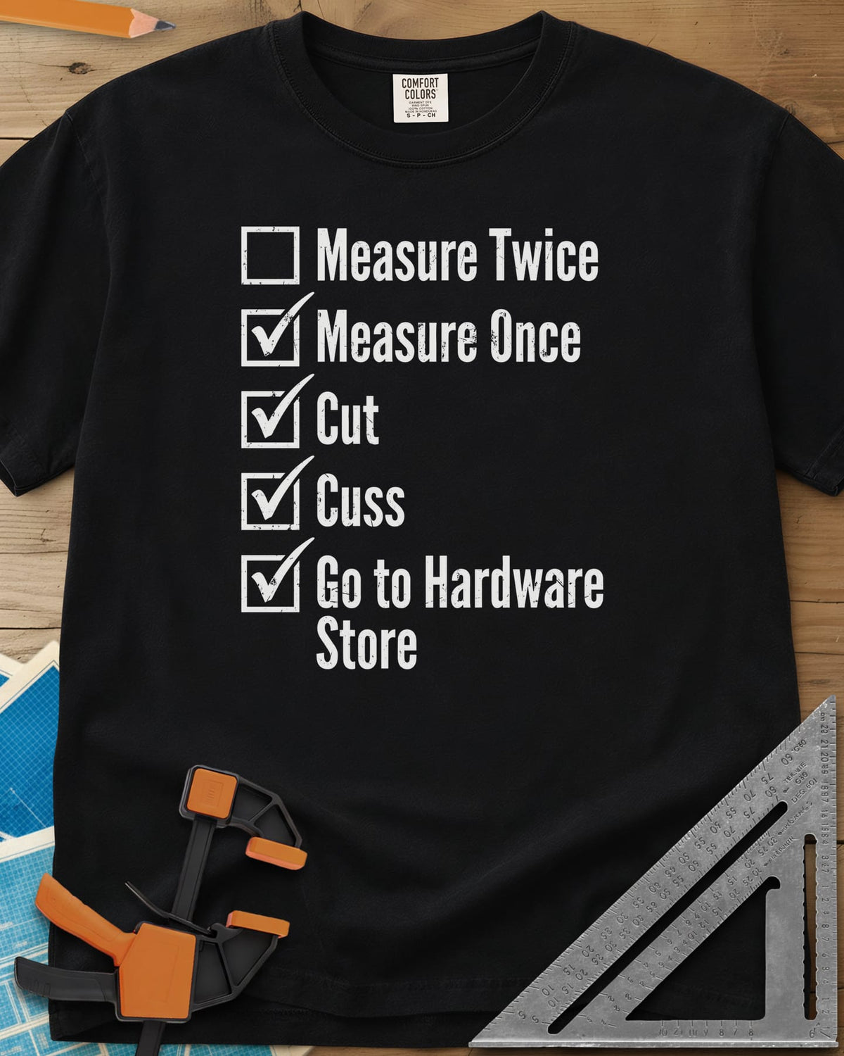 Measure Twice Checkbox heavyweight tee in Black, a five-line checklist with only the measure twice box left empty