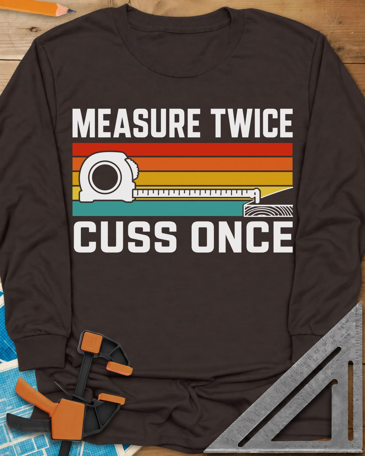 Measure Twice Cuss Once long sleeve shirt in Dark Chocolate, a white tape measure across retro red, orange, gold and teal