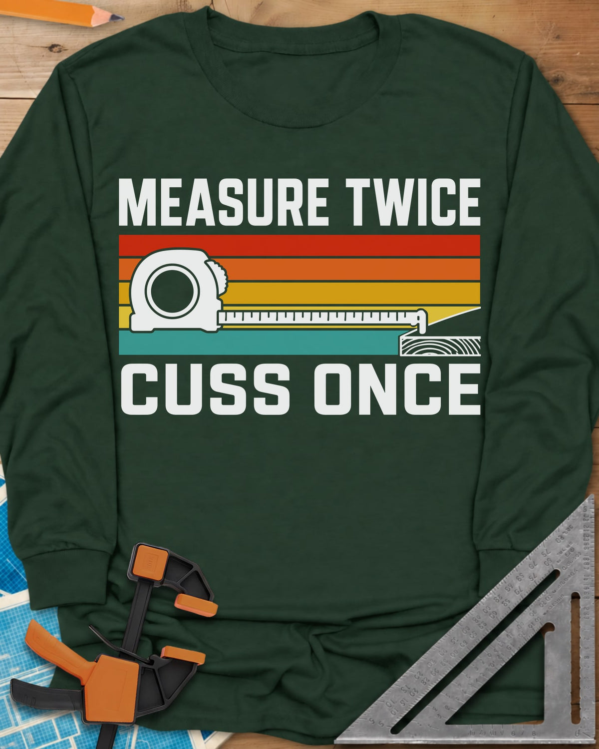 Measure Twice Cuss Once long sleeve shirt in Forest Green, a white tape measure across retro red, orange, gold and teal
