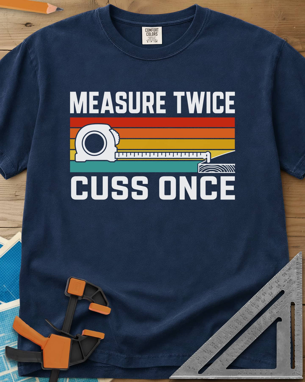 Measure Twice Cuss Once heavyweight tee in Navy, a white tape measure across retro red, orange, gold and teal stripes