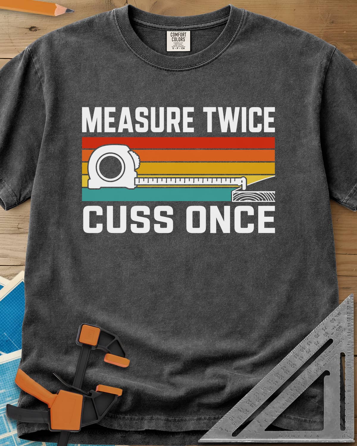 Measure Twice Cuss Once heavyweight tee in Pepper, a white tape measure across retro red, orange, gold and teal stripes