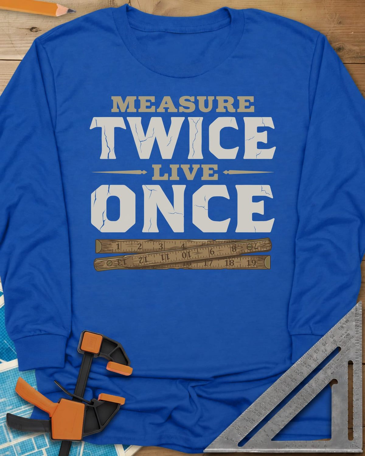 Measure Twice Live Once long sleeve shirt in Royal, cracked block letters above a worn wooden folding rule