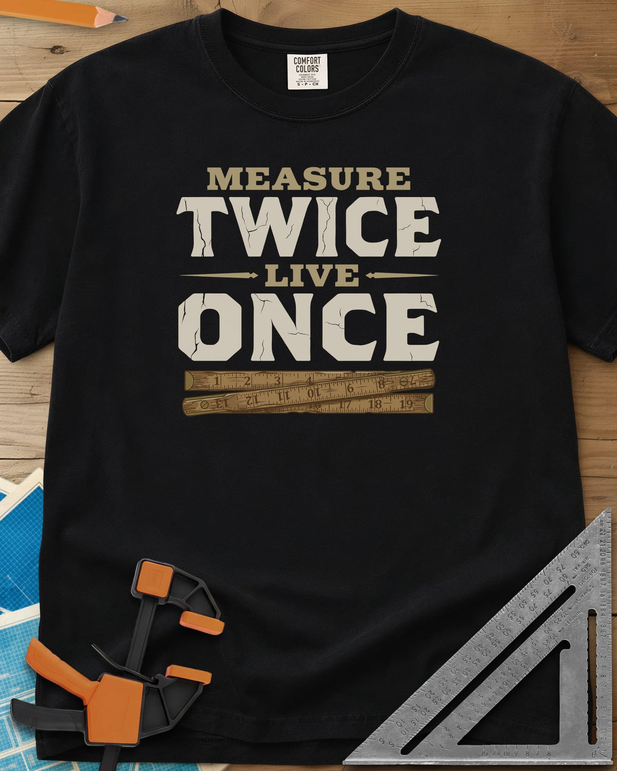 Measure Twice Live Once heavyweight tee in Black, cracked block letters above a worn wooden folding rule