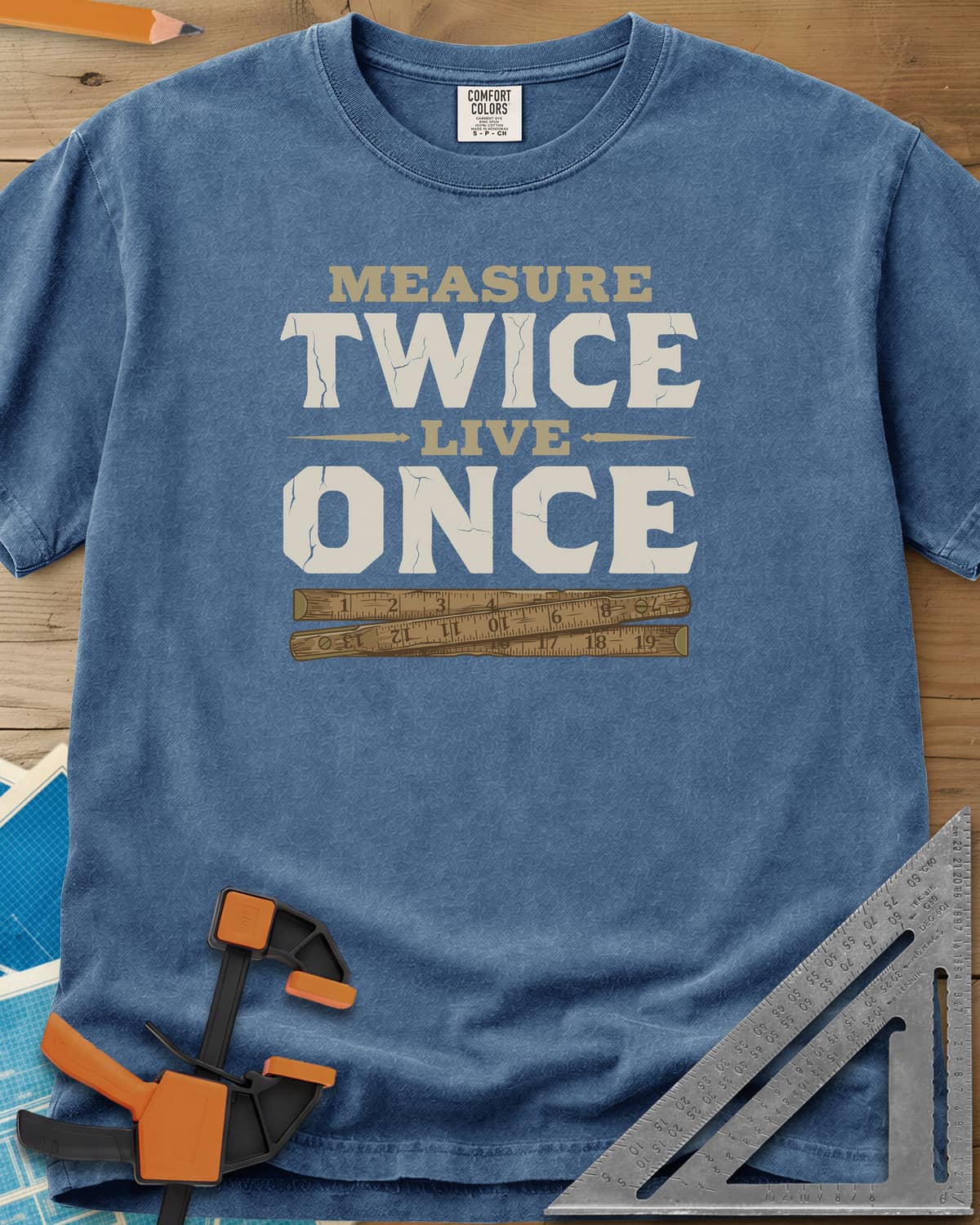 Measure Twice Live Once heavyweight tee in Blue Jean, cracked block letters above a worn wooden folding rule