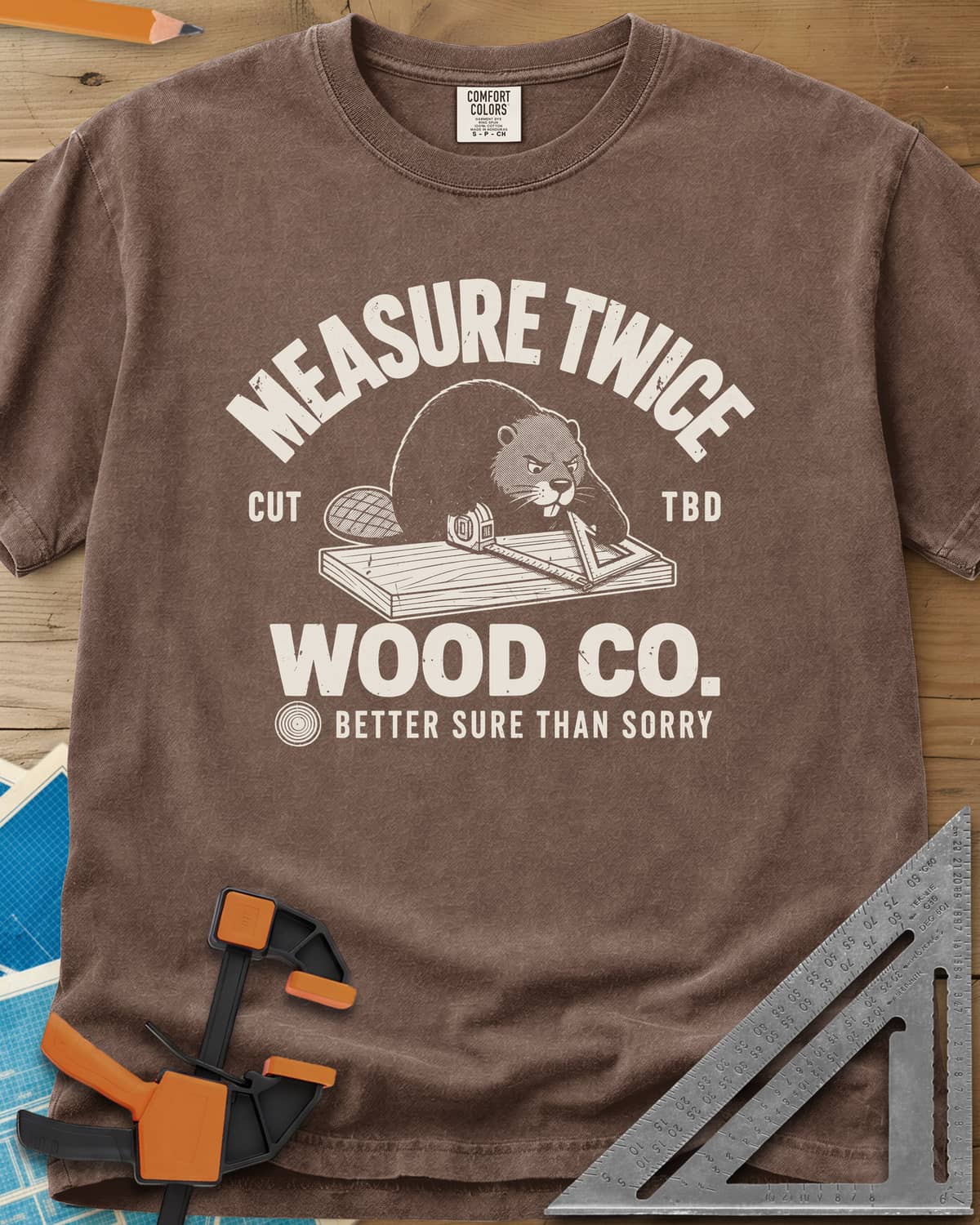 Measure Twice heavyweight tee in Espresso, a determined beaver measuring a board in a Wood Co. badge