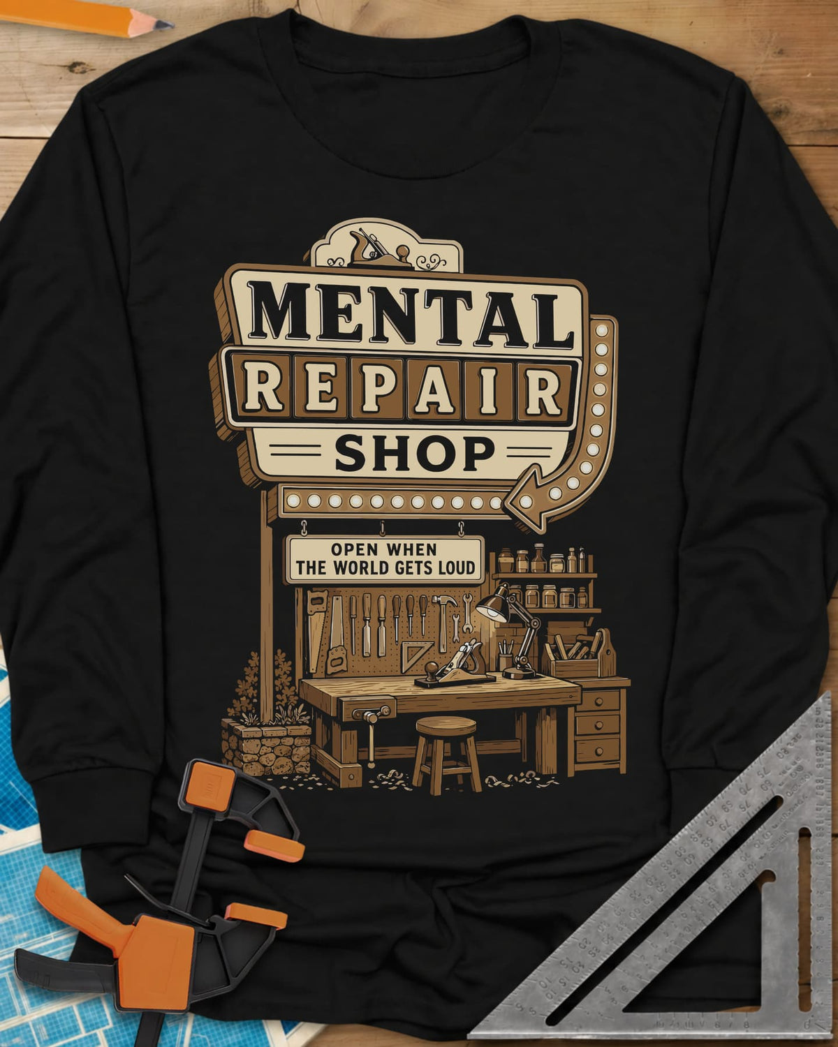 Mental Repair Shop long sleeve shirt in Black, a retro roadside sign over a tidy woodworking bench and pegboard