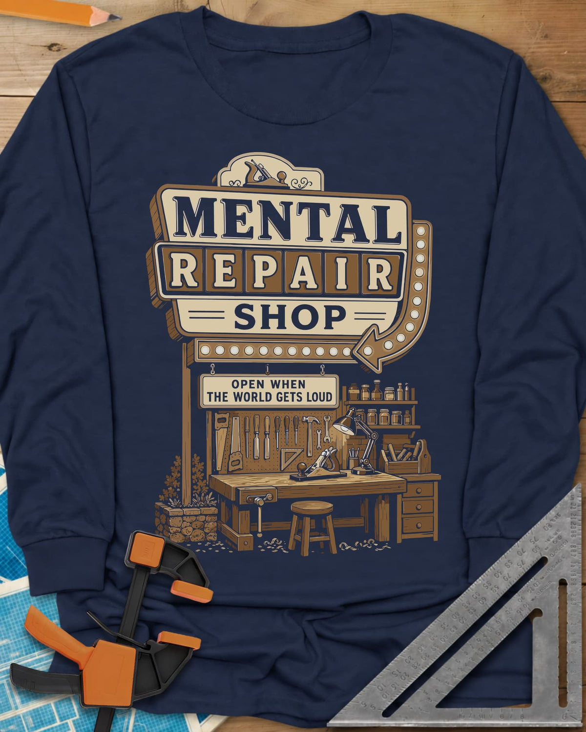 Mental Repair Shop long sleeve shirt in Navy, a retro roadside sign over a tidy woodworking bench and pegboard