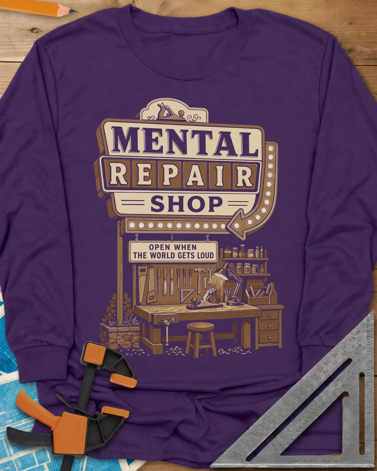 Mental Repair Shop long sleeve shirt in Purple, a retro roadside sign over a tidy woodworking bench and pegboard