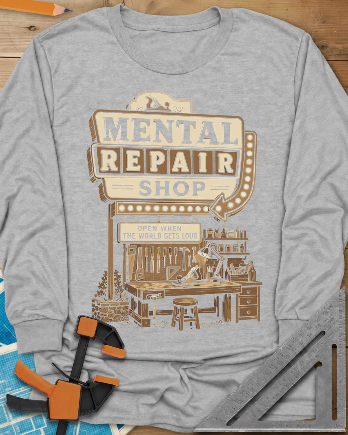 Mental Repair Shop long sleeve shirt in Sport Grey, a retro roadside sign over a tidy woodworking bench and pegboard