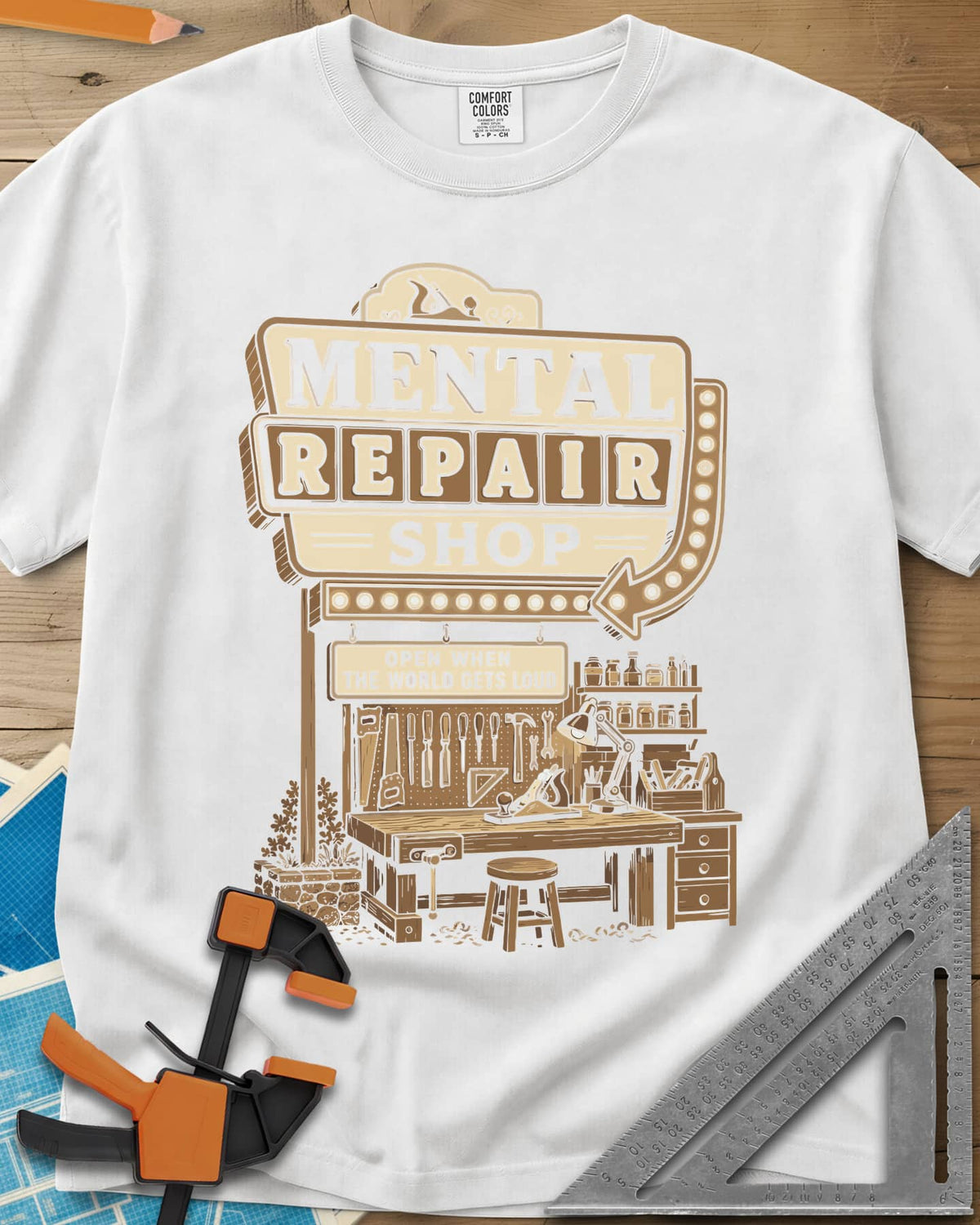Mental Repair Shop heavyweight tee in White, a retro roadside sign over a tidy woodworking bench and pegboard