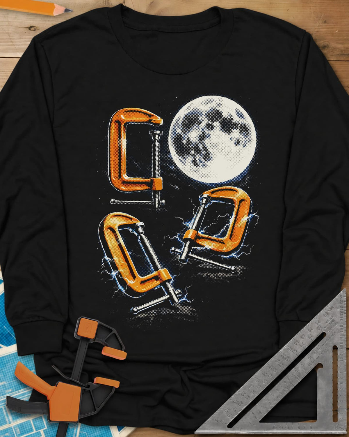 Midnight Clamp Trio long sleeve shirt in Black, three orange C-clamps under a full moon with blue sparks