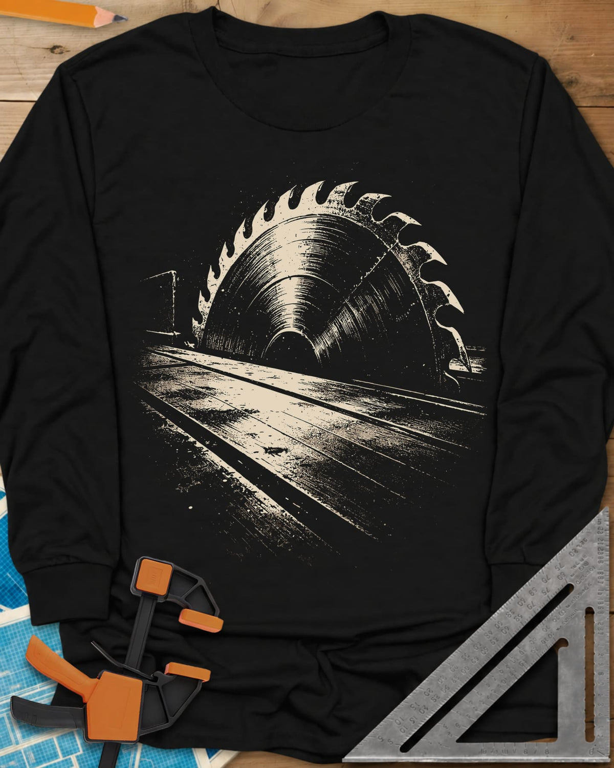 Midnight Table Saw long sleeve shirt in Black, a grainy cream saw blade rising over a long table, no words