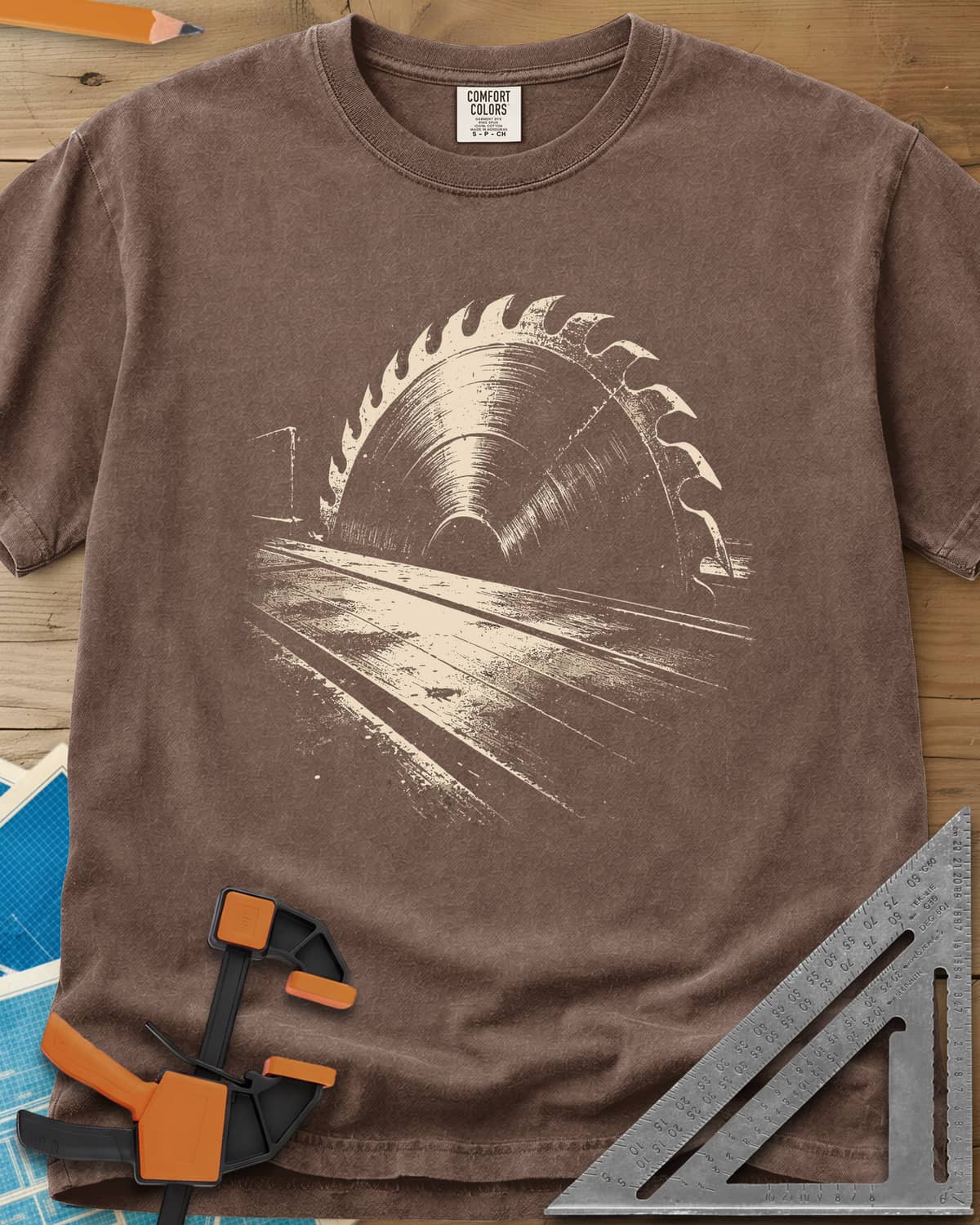 Midnight Table Saw heavyweight tee in Espresso, a grainy cream saw blade rising over a long table, no words