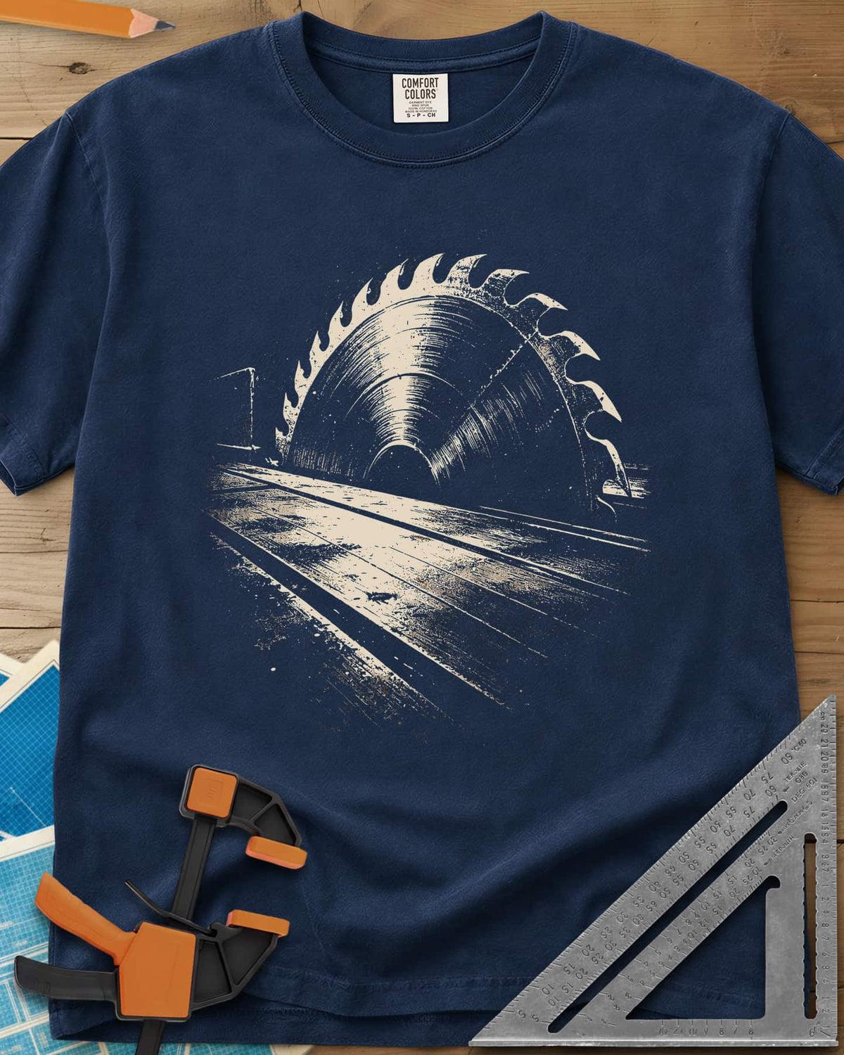 Midnight Table Saw heavyweight tee in Navy, a grainy cream saw blade rising over a long table, no words