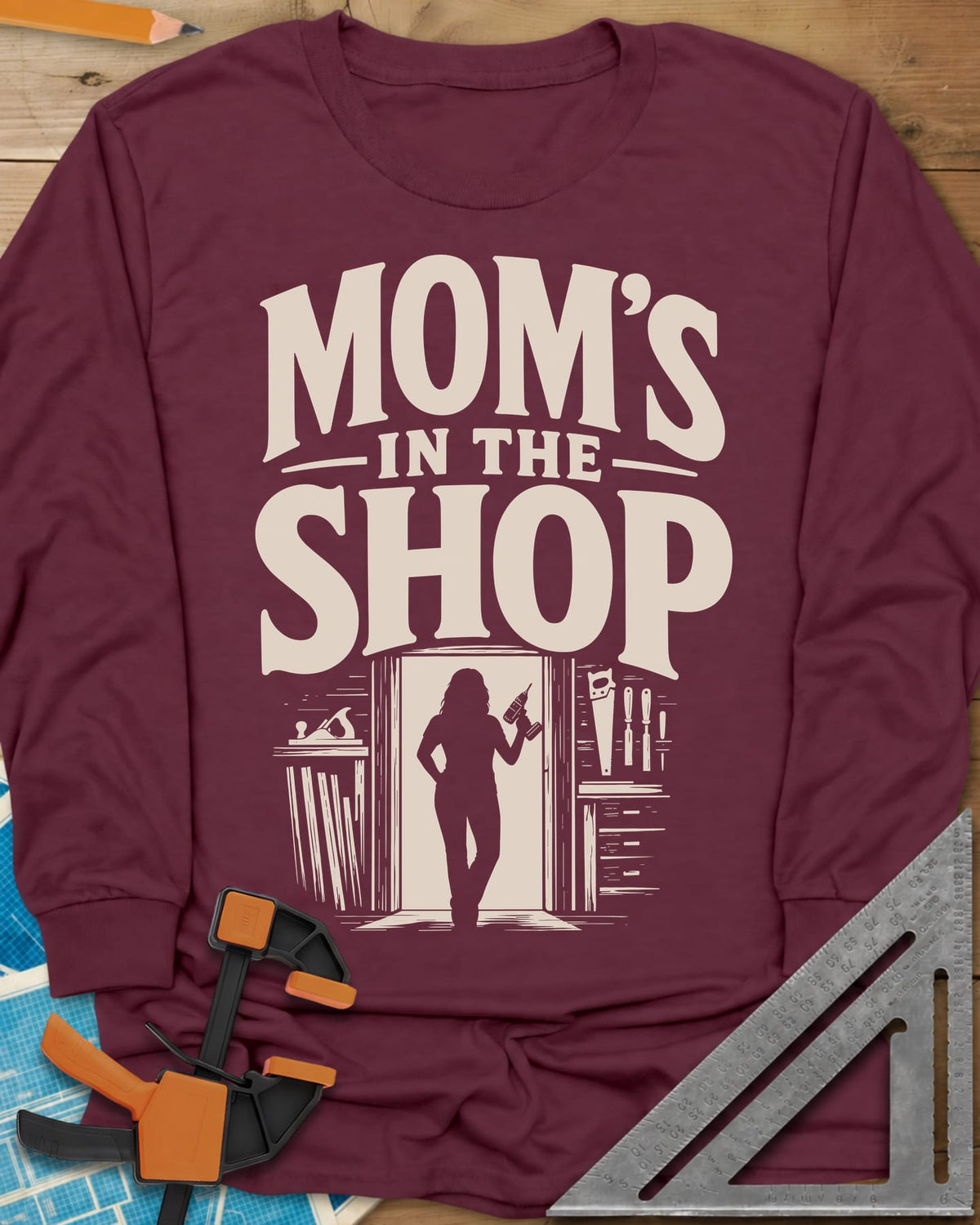 Mom'S Shop long sleeve shirt in Maroon, silhouette of a woman with a cordless drill in a shop doorway